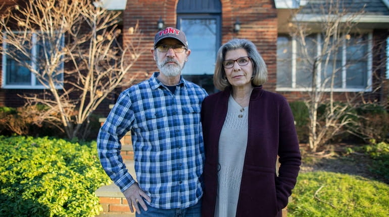 Mark and Marcie Herzog, of Rockville Centre, outside their home...