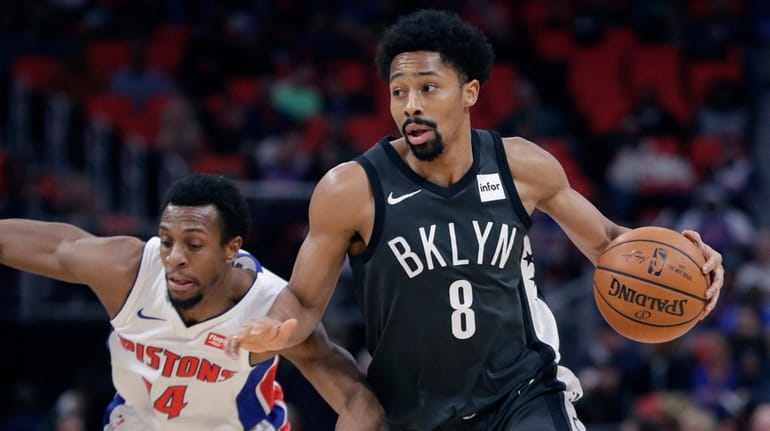 Nets guard Spencer Dinwiddie drives around Pistons guard Ish Smith...