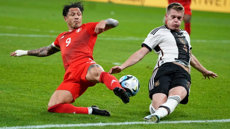 Peru's Gianluca Lapadula vies for the ball with Germany's Matthias...