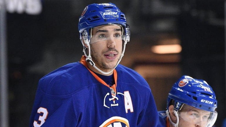 New York Islanders defenseman Travis Hamonic looks on from the...