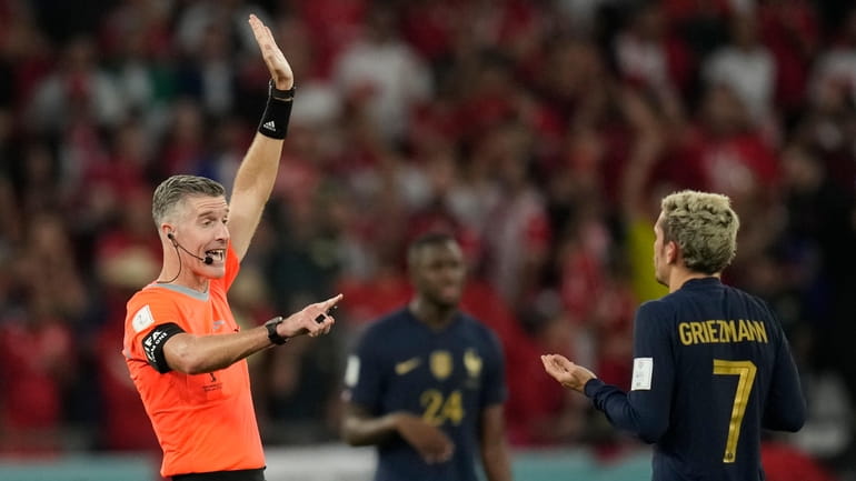 Referee Matthew Conger gestures towards France's Antoine Griezmann as his...