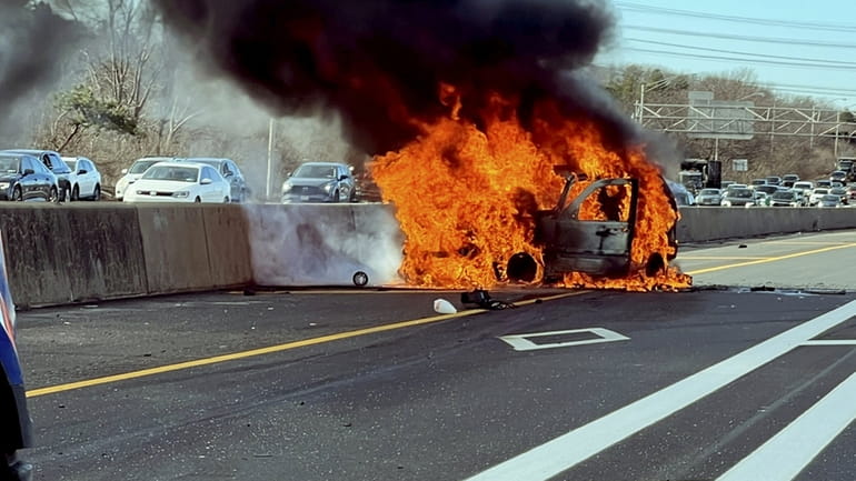 A car is engulfed in flames on the Long Island...