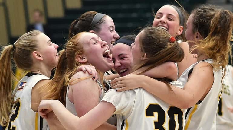 Wantagh teammates celebrate after their 42-35 win over Manhasset in...