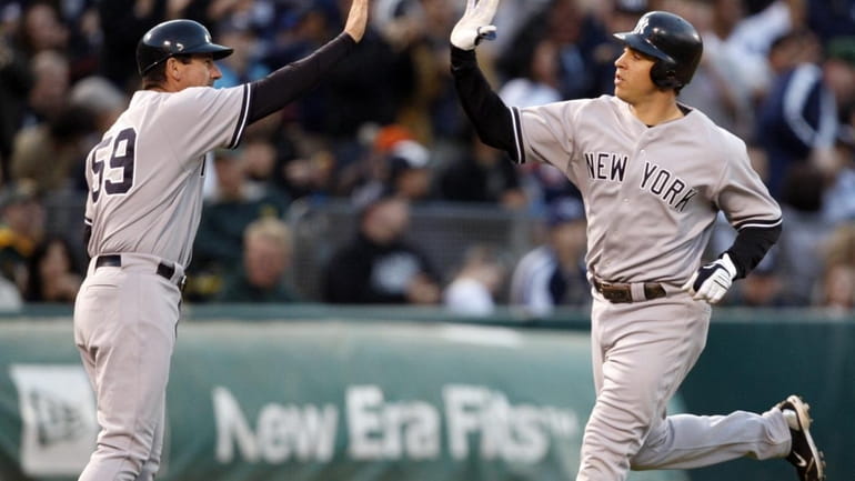 New York Yankees' Mark Teixeira, right, is congratulated by third...