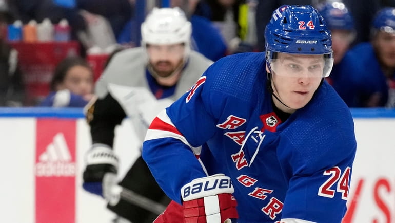 Rangers right wing Kaapo Kakko carries the puck in front...