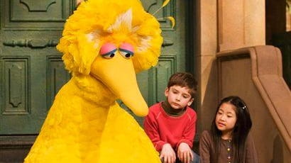 Big Bird reads to Connor Scott and Tiffany Jiao during...