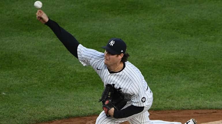 Yankees starting pitcher Gerrit Cole delivers against the Baltimore Orioles...