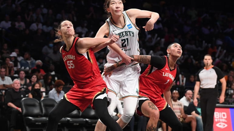 New York Liberty center Han Xu vies for position against...