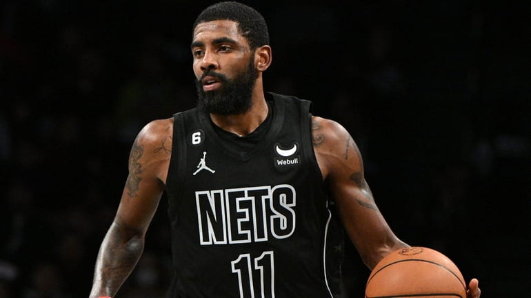 Nets guard Kyrie Irving controls the ball against the Indiana...