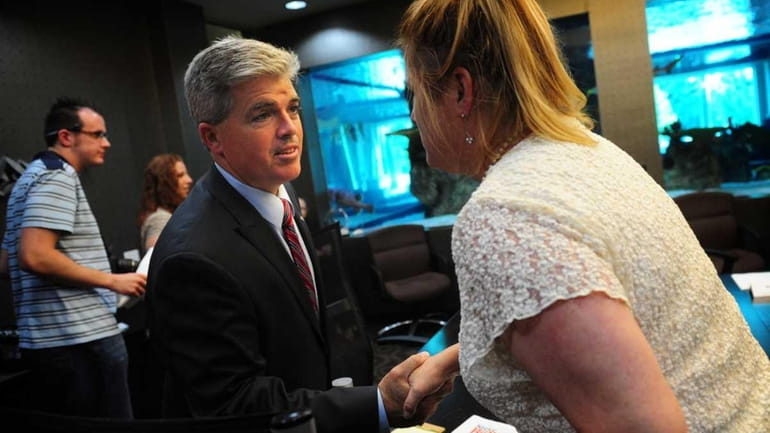 Suffolk County Executive candidate Steve Bellone , left, greets participants...