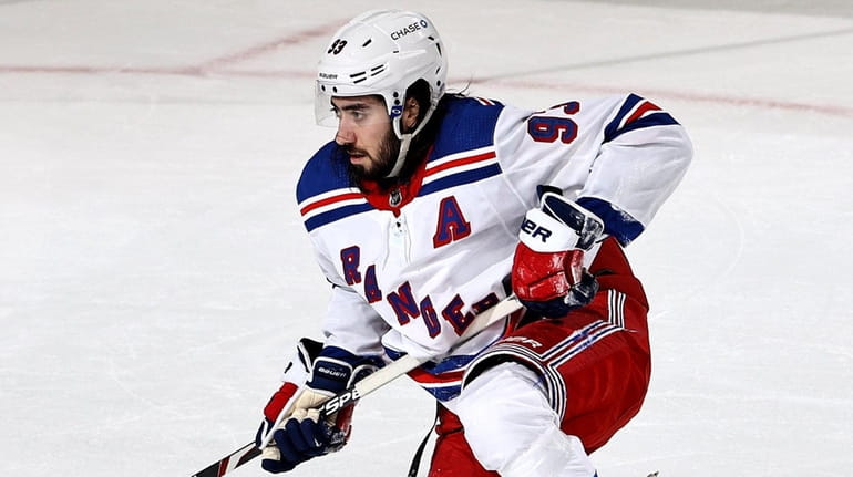 Mika Zibanejad of the Rangers gets up slowly after a...