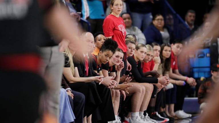 Players and staff on the Utah bench react toward the...