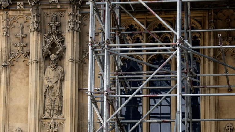 A detailed figure near scaffolding on Britain's Houses of Parliament...
