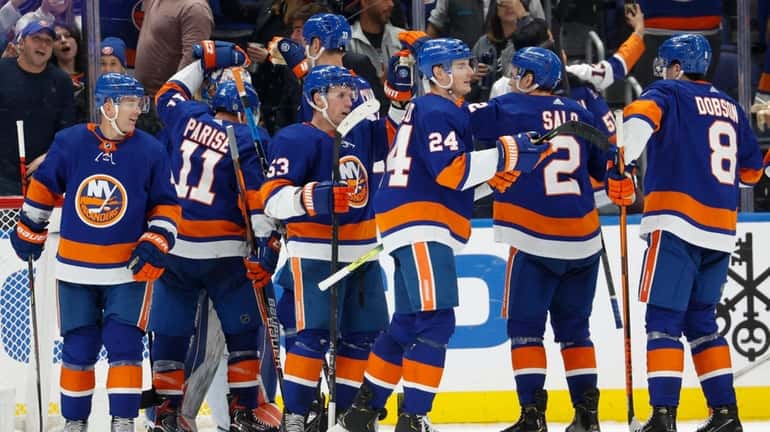 The Islanders celebrate their win against the Devils on Saturday.