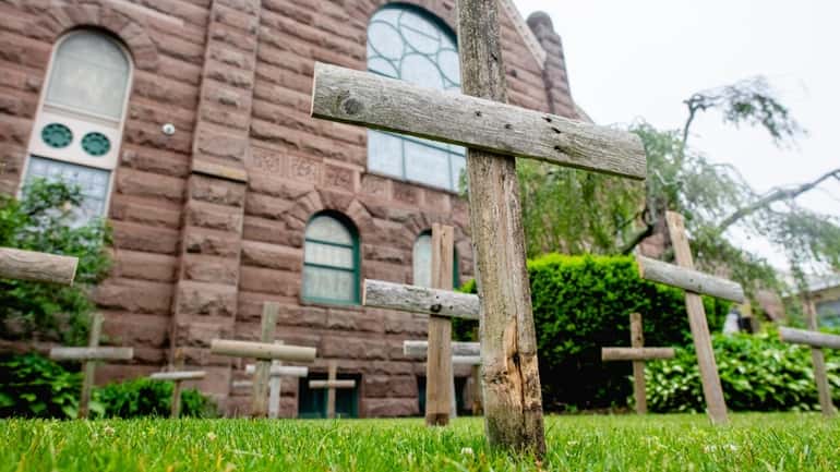 Twenty-one wooden crosses, to memorialize the 19 schoolchildren and two teachers killed...