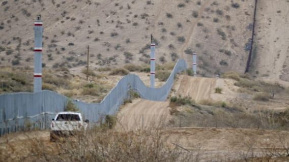 A U.S. Border Patrol agent drives near the U.S.-Mexico border...