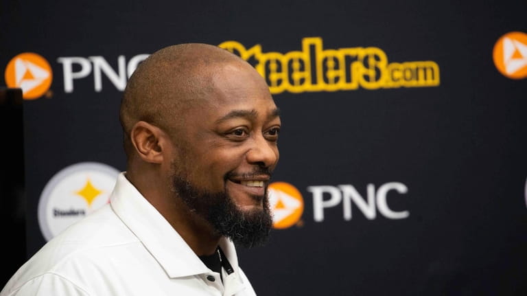 Pittsburgh Steelers head coach Mike Tomlin reacts as he listens...