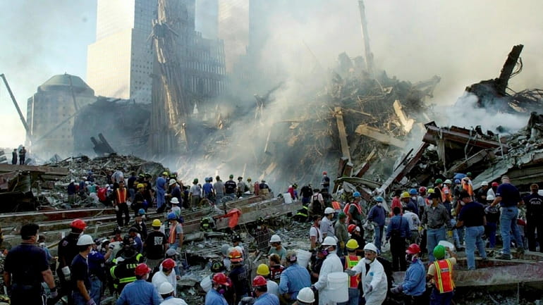 Two days after the Sept. 11 attacks, rescue crews remove...