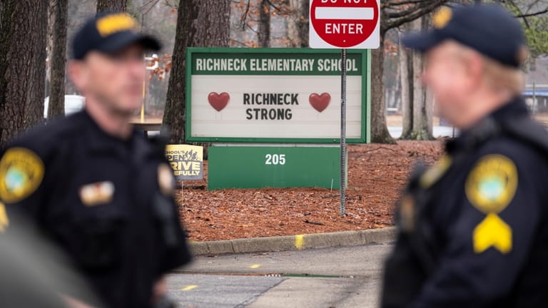 Police look on as students return to Richneck Elementary School...
