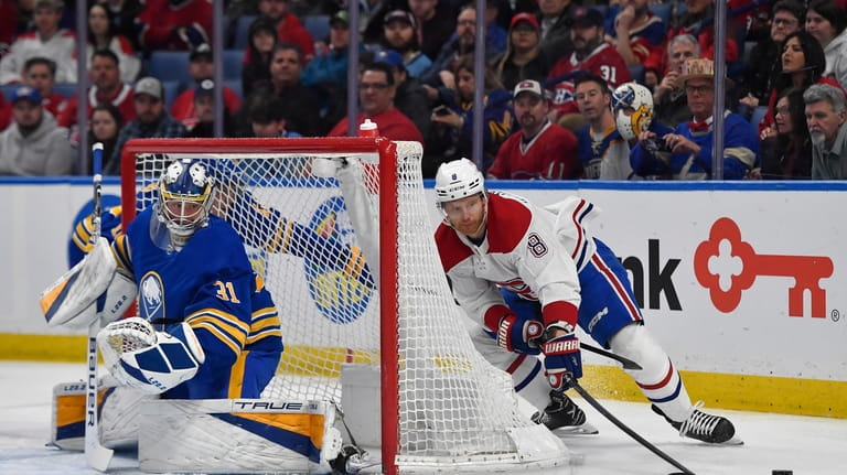 Montreal Canadiens defenseman Mike Matheson, right, loses the puck as...