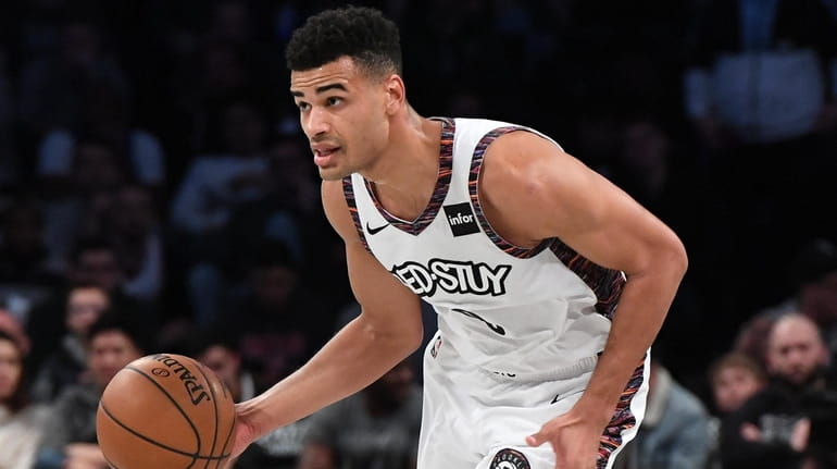 The Nets' Timothe Luwawu-Cabarrot controls the ball against the 76ers...