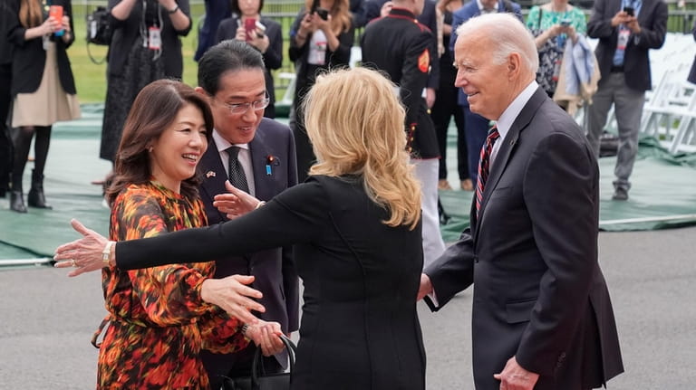 President Joe Biden, far right, and first lady Jill Biden...