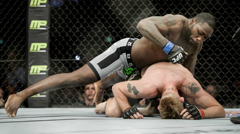 Anthony 'Rumble' Johnson, top, fights Alexander 'The Mauler' Gustafsson in their...