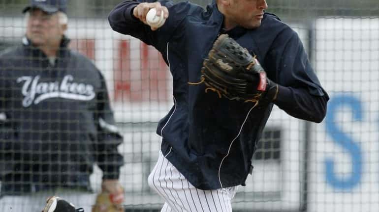New York Yankees shortstop Derek Jeter fields a ball and...