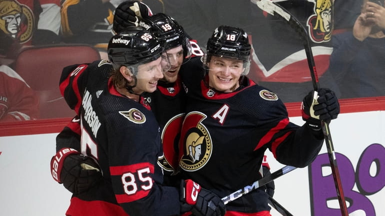 Ottawa Senators' Drake Batherson, center, celebrates his game winning goal...