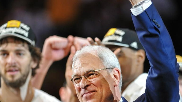Los Angeles Lakers coach Phil Jackson acknowledges the crowd following...