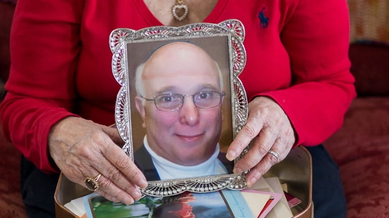 Fran Boim holds a photo of her husband, Jeff.



	 