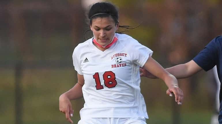 Avani Brandt of Syosset moves the ball under pressure from...