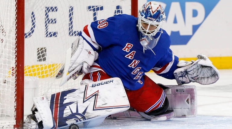 Henrik Lundqvist of the Rangers makes a save against the...