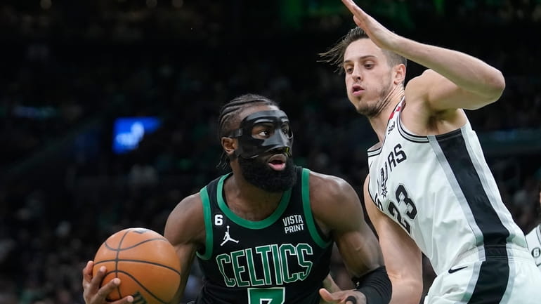 Boston Celtics guard Jaylen Brown (7) drives toward the basket...