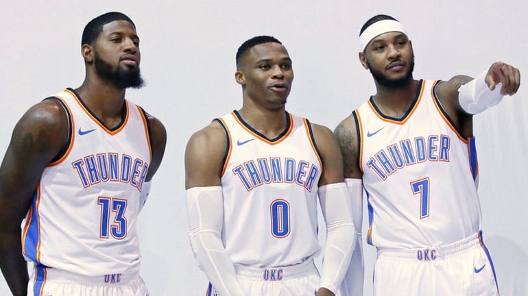 Oklahoma City Thunder's Paul George (13), Russell Westbrook (0) and...