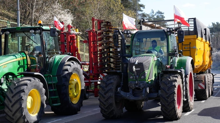 Tractors line up to block a road near the German...