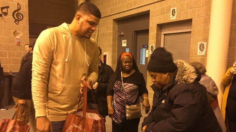 Yankees pitcher Dellin Betances hands out Thanksgiving turkeys Tuesday night at the...