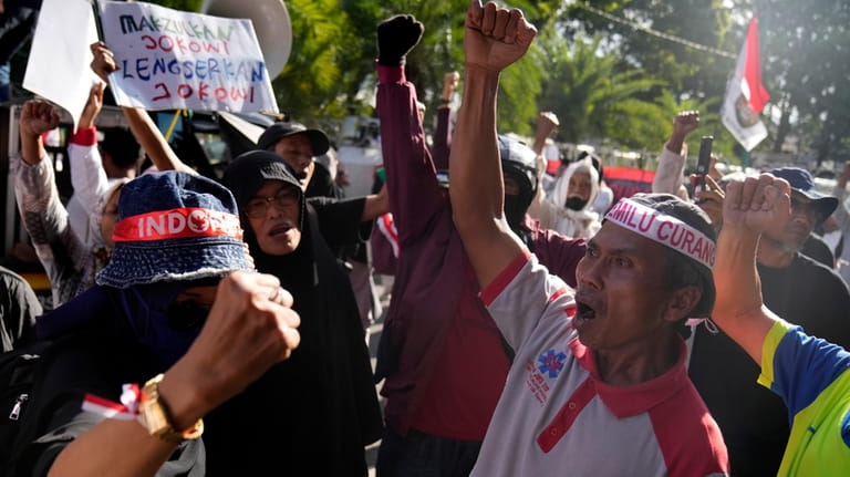 Protesters shout slogans during a rally alleging a widespread fraud...