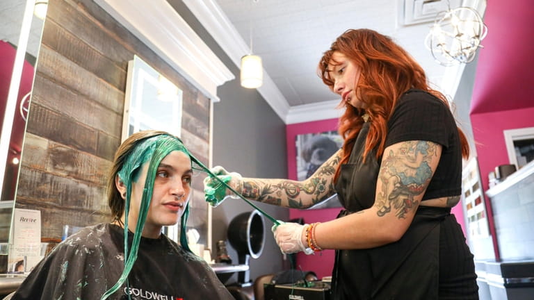 Sarah Mason, 22, of Coram, gets her hair colored by color...
