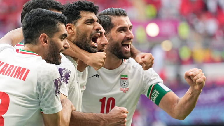 Iran's team players celebrate at the end of the World...