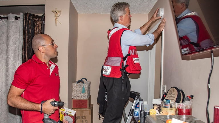 John Waldman, left, regional senior director for the American Red Cross'...