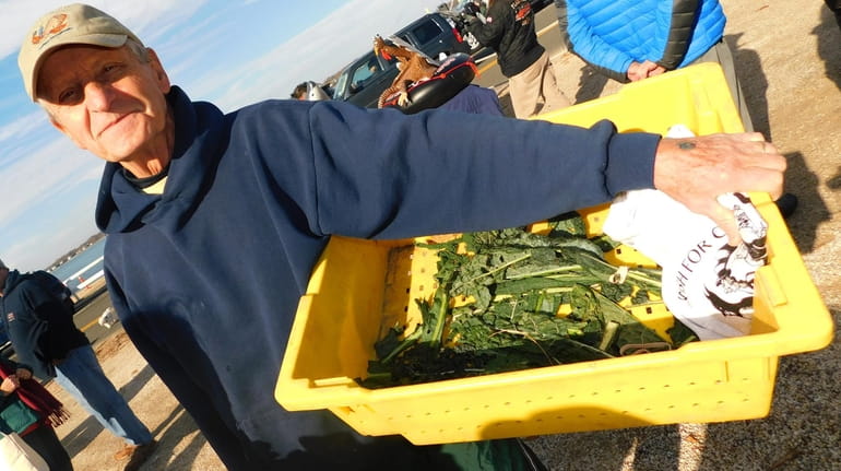Peter Vielbig of Shelter Island hands out kale grown at...
