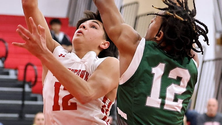 Smithtown East guard Ben Haug drives for two points against...