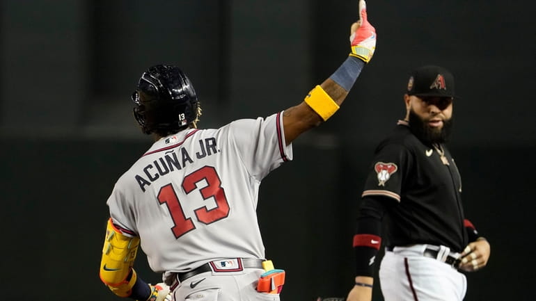 Atlanta Braves' Ronald Acuña Jr. celebrates his solo home run,...