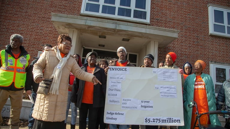Hempstead residents rally over housing rates outside village hall in Garden...