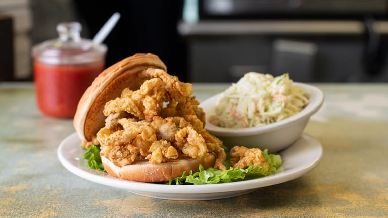 A fried Ipswich clam sandwich with coleslaw served at Bigelow's...