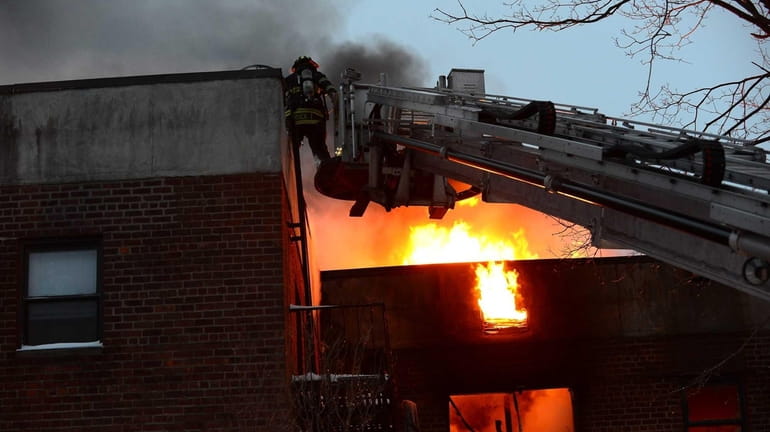 Firefighters fight the blaze which started at 6:20 a.m. on...