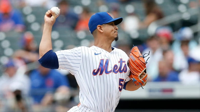 Carlos Carrasco #59 of the Mets pitches in the first inning...