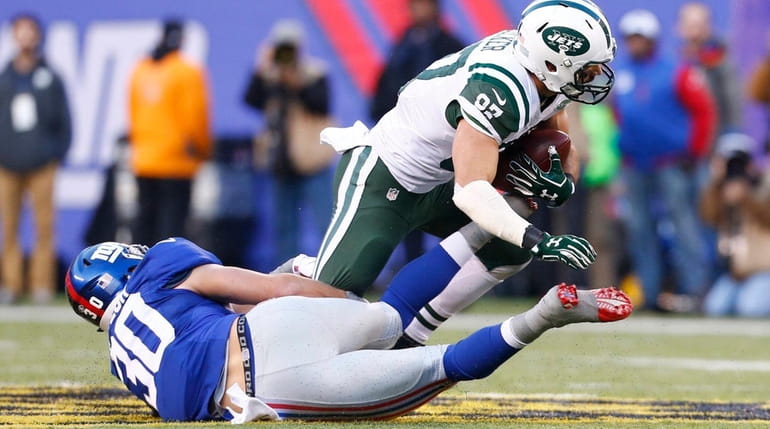 Giants safety Cooper Taylor tries to tackle Jets receiver Eric...