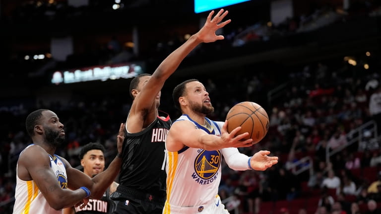 Golden State Warriors' Stephen Curry (30) shoots as Houston Rockets'...